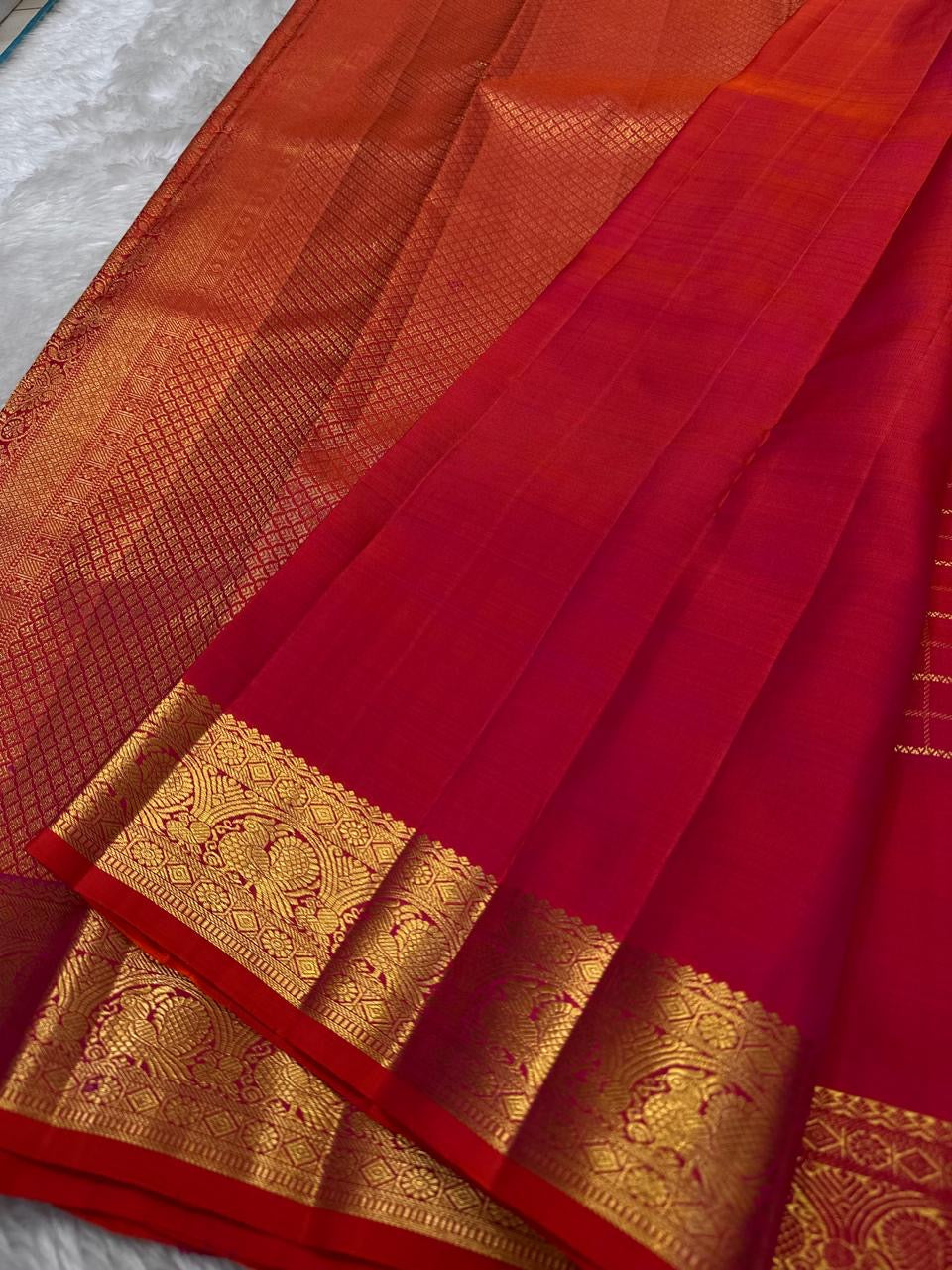 Close view of antique-gold checked zari grid on Chilli Reddish Pink Kanjivaram silk.