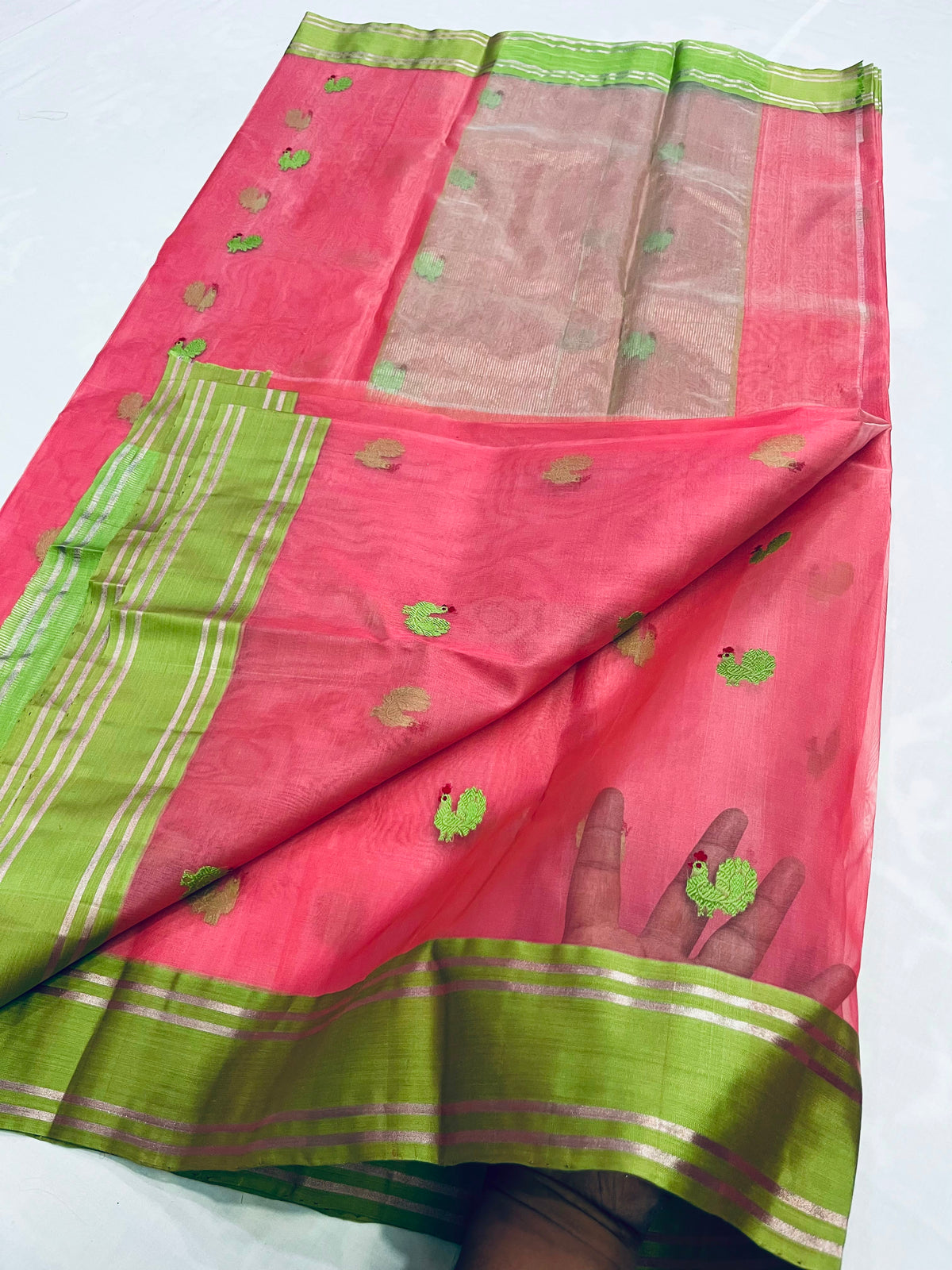 Pink and green handloom Katan Silk Chanderi saree draped to show body and border