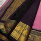 Close view of black zari pallu with dense gold zari patterns, green accent threads, and tassels on a pink silk saree