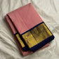 Folded rose pink Kanchipuram silk saree with navy border and gold zari woven panel detailing