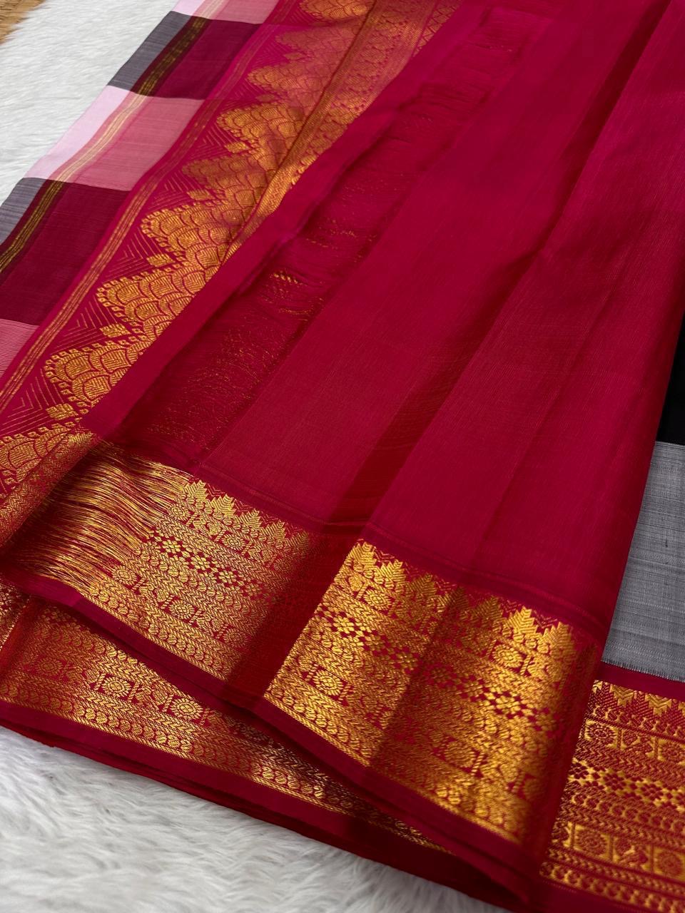 Close-up of deep red pallu section with gold zari woven border and fine silk texture