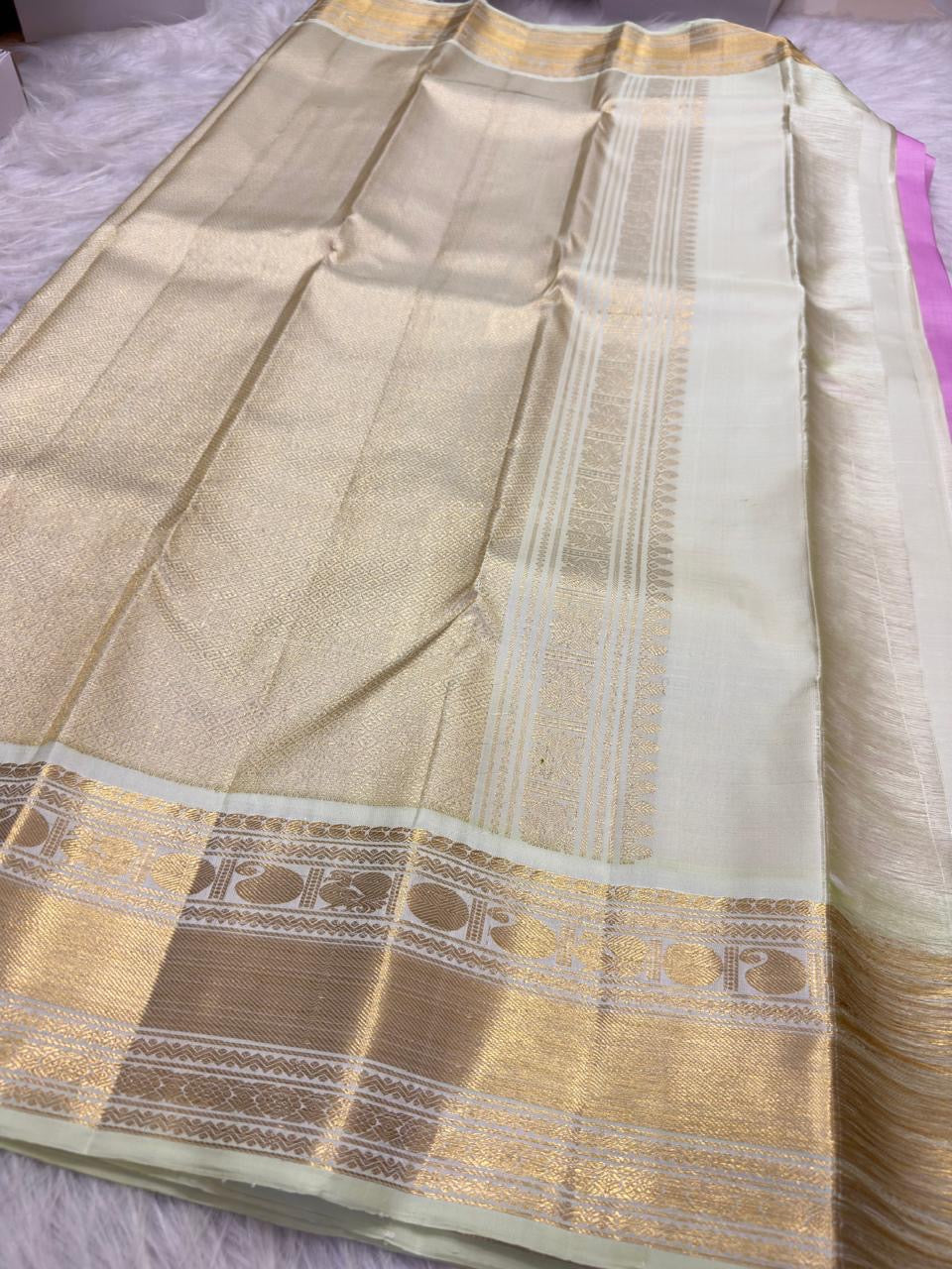 Gold zari bird motifs woven along ivory Pure Silk Kanchipuram Korvai border