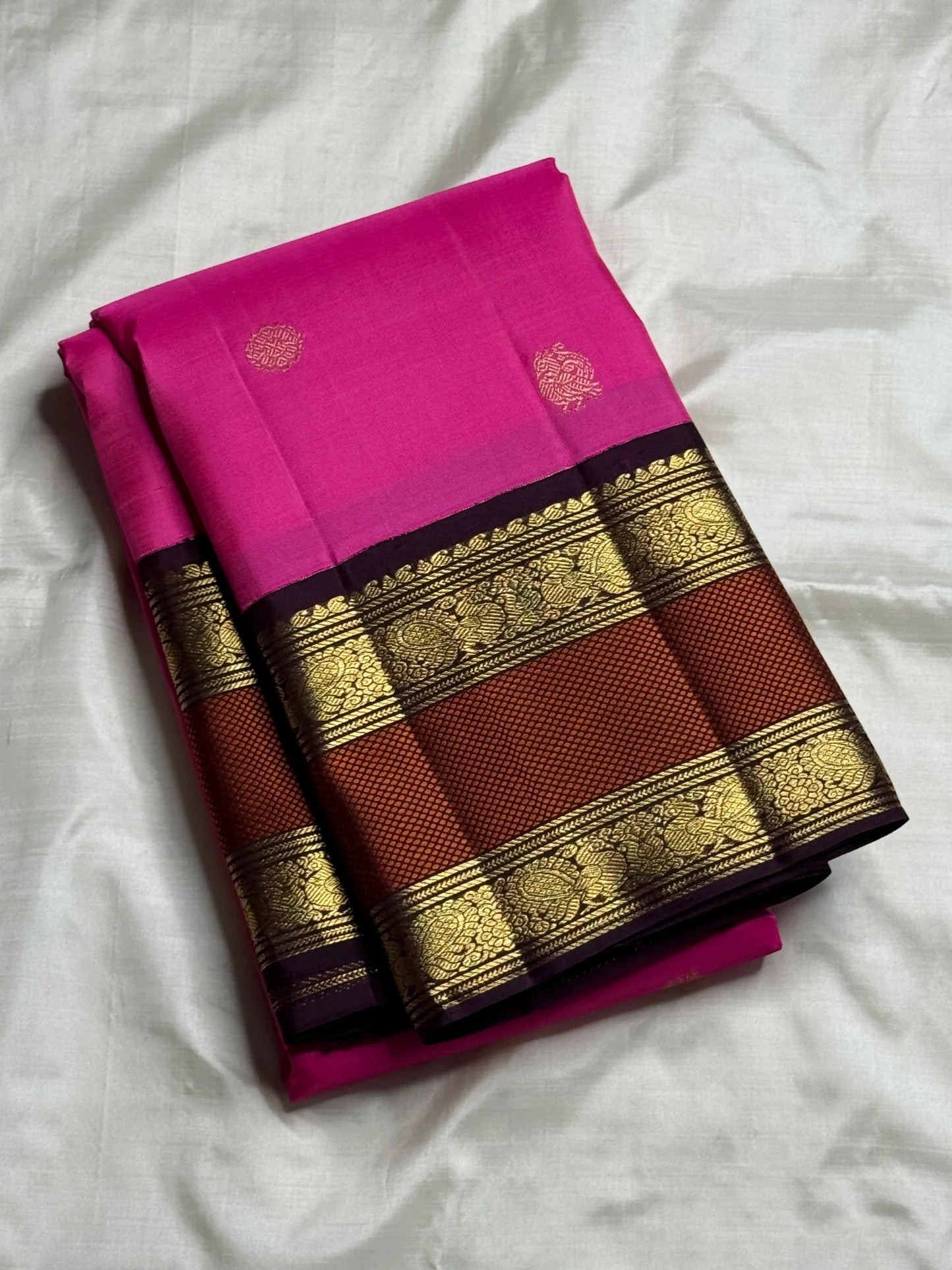Traditional Kanjivaram saree in jewel pink silk with antique gold zari and woven peacock motifs