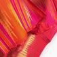 Pink Sunset Orange Kanchipuram saree with traditional Ettukol weaving.