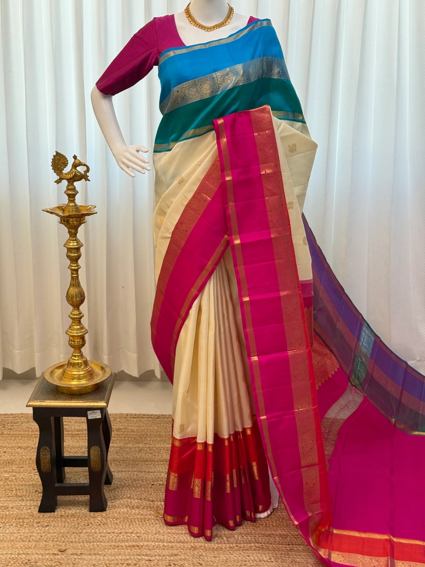 Pallu detail in hot pink with zari woven patterning and a blue-purple contrast end panel.