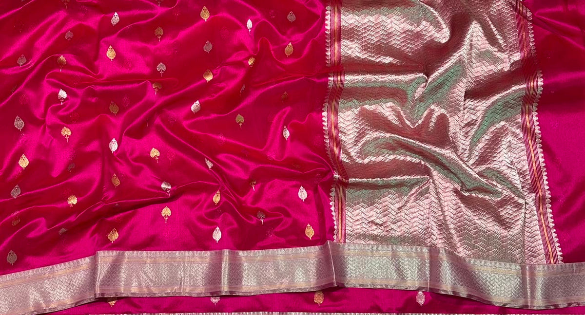 Close-up of scattered gold leaf buttas on the Rani Pink Pattu Silk Chanderi saree.