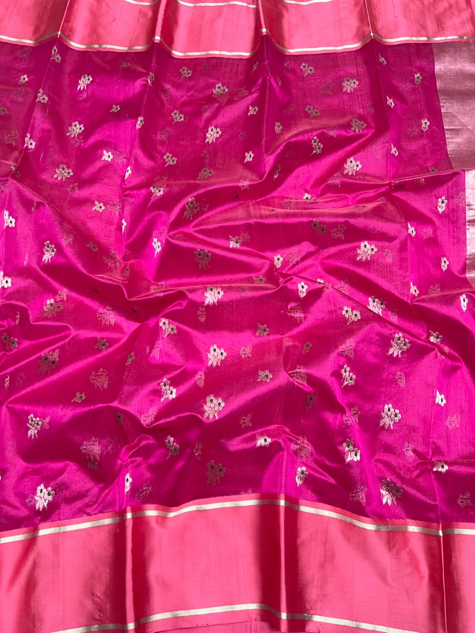 Silver floral sprig motif close-up on pink silk body