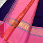 Pink saree with a decorative border on a textured surface