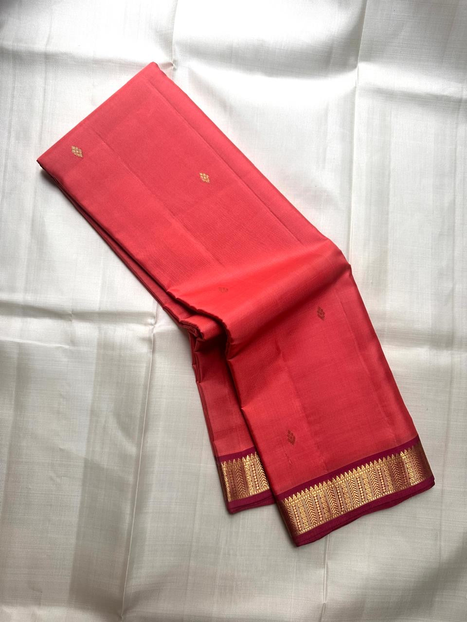 coral pink lightweight pure kanchipuram silk saree body spread showing small woven buttas