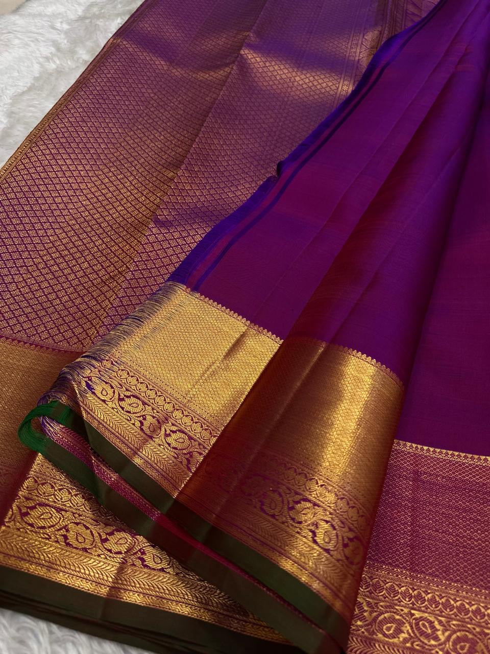 Close view of traditional Thazhampoo Reku zari butta on Rani Pink Kanchipuram silk.