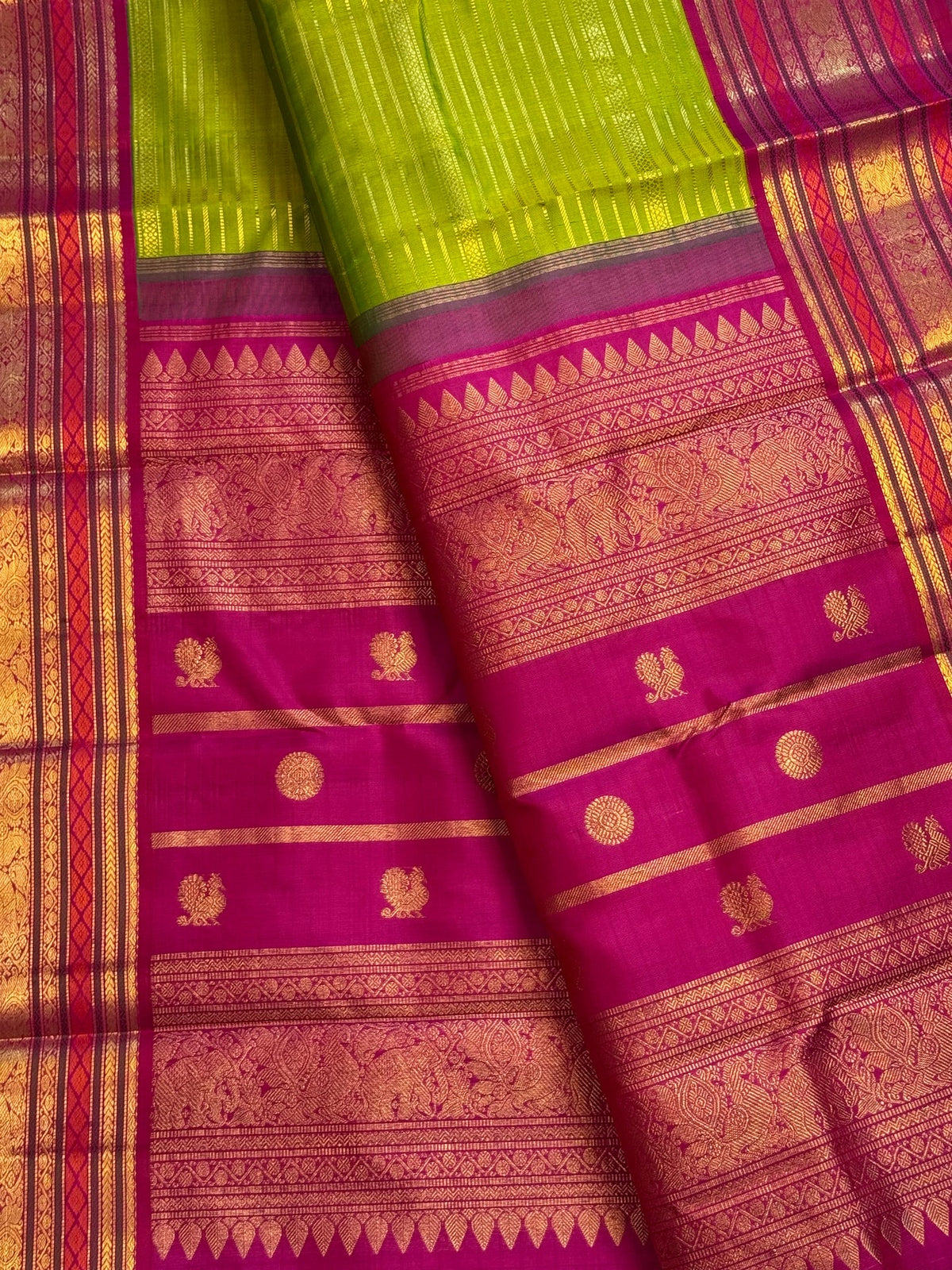 Jewel-toned pink Vanasringaram border and pallu on a green Pure Silk Kanchipuram saree.