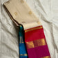 Hot pink bordered Kanchipuram silk saree fold showing wide zari woven panel and teal-blue contrast beneath.
