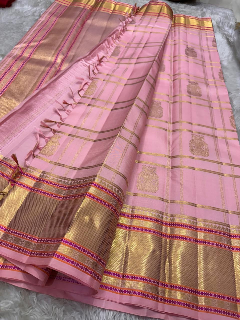 Close-up of Gandaberunda zari butta on blush pink Kanjeevaram Zari Kattam saree