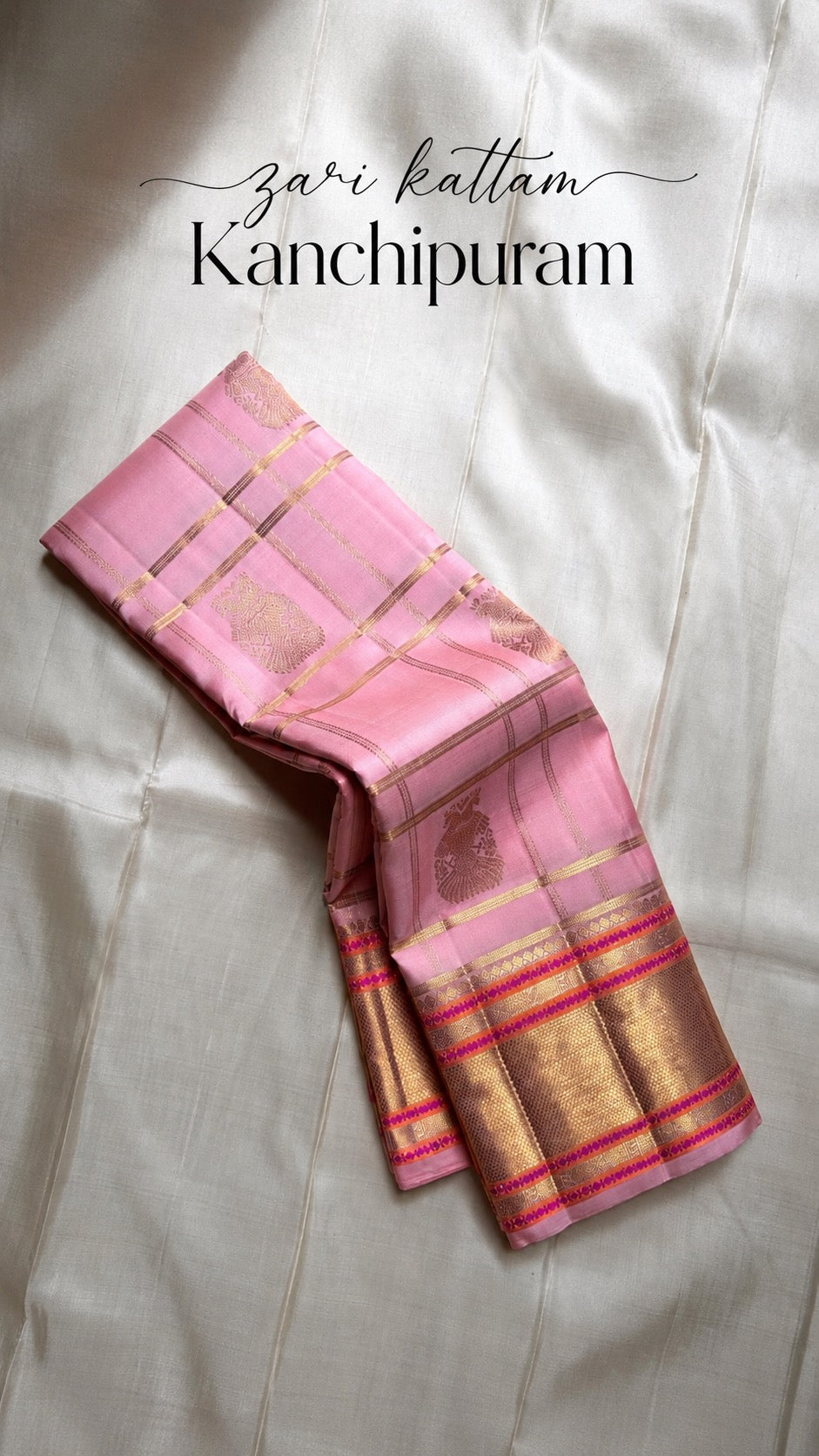 Blush pink Kanjeevaram Zari Kattam saree with Gandaberunda buttas, folded view