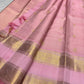 Close-up of gold zari buttas on blush pink Kanjipuram Zari Kattam saree