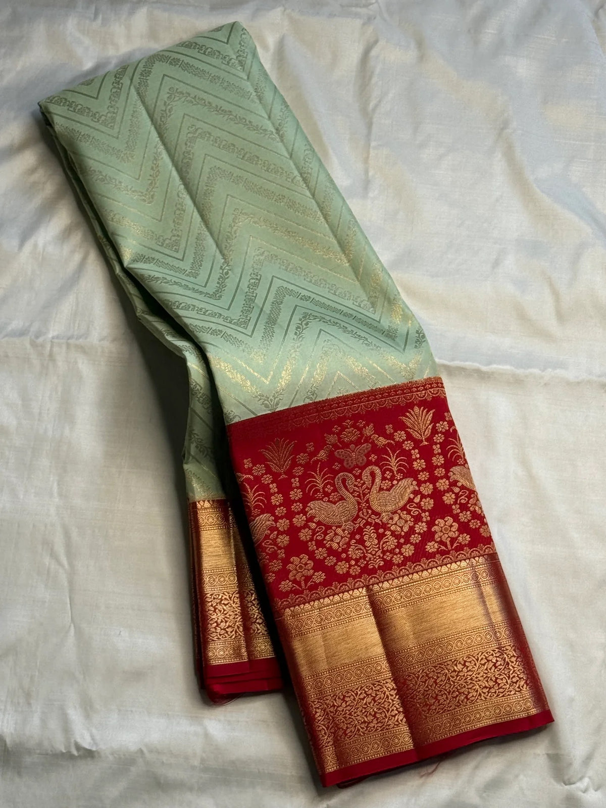 Pista green handwoven pure silk Kanchipuram Butta saree with red zari border