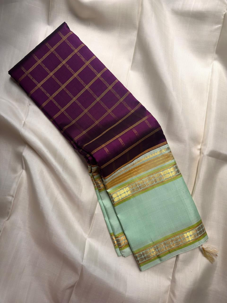 Handwoven Pista Green Kanchipuram silk saree with all-over antique gold zari checks