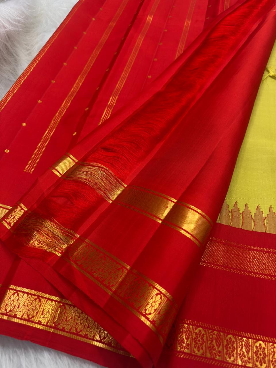 Golden radiant green handwoven Kanjivaram korvai saree with vermilion red border