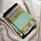 Close view of antique gold zari checks woven across Pista Green Kanchipuram silk