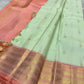 Tender pistachio-green Kanchipuram silk body showing generously spaced petite traditional gold zari buttas.