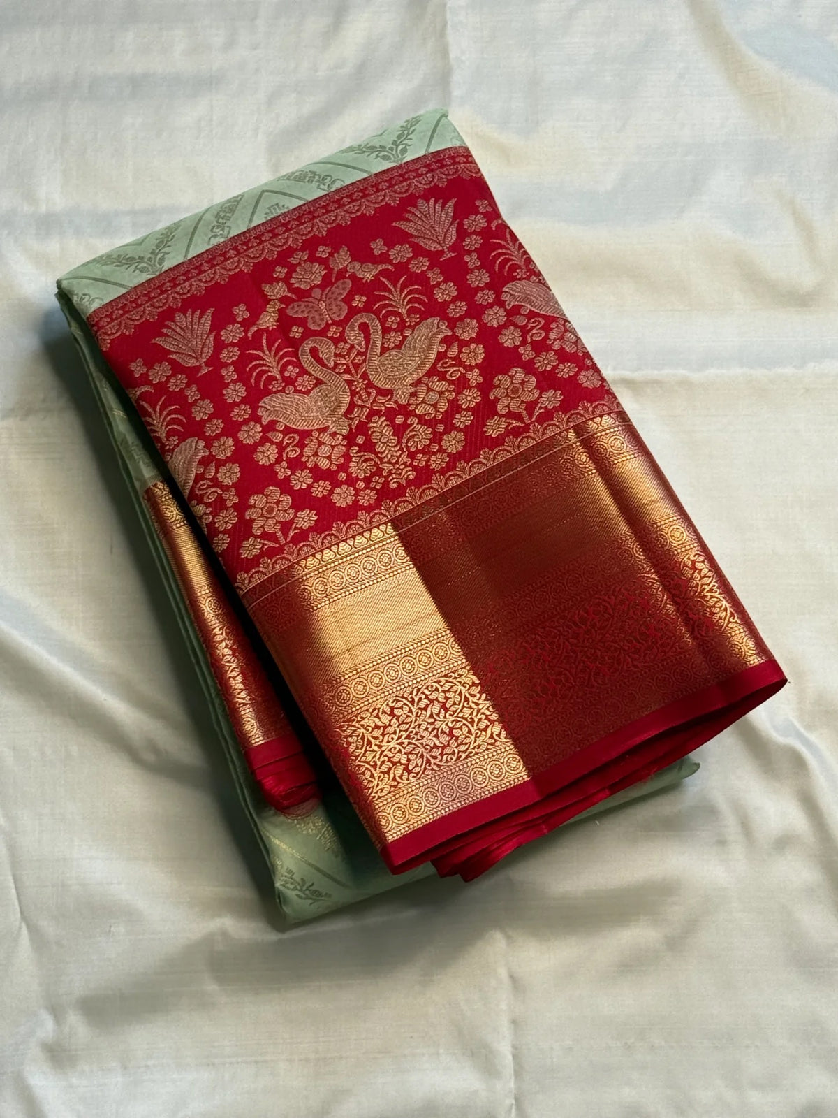 Close-up of the red zari border on the Pista green Kanjivaram silk saree