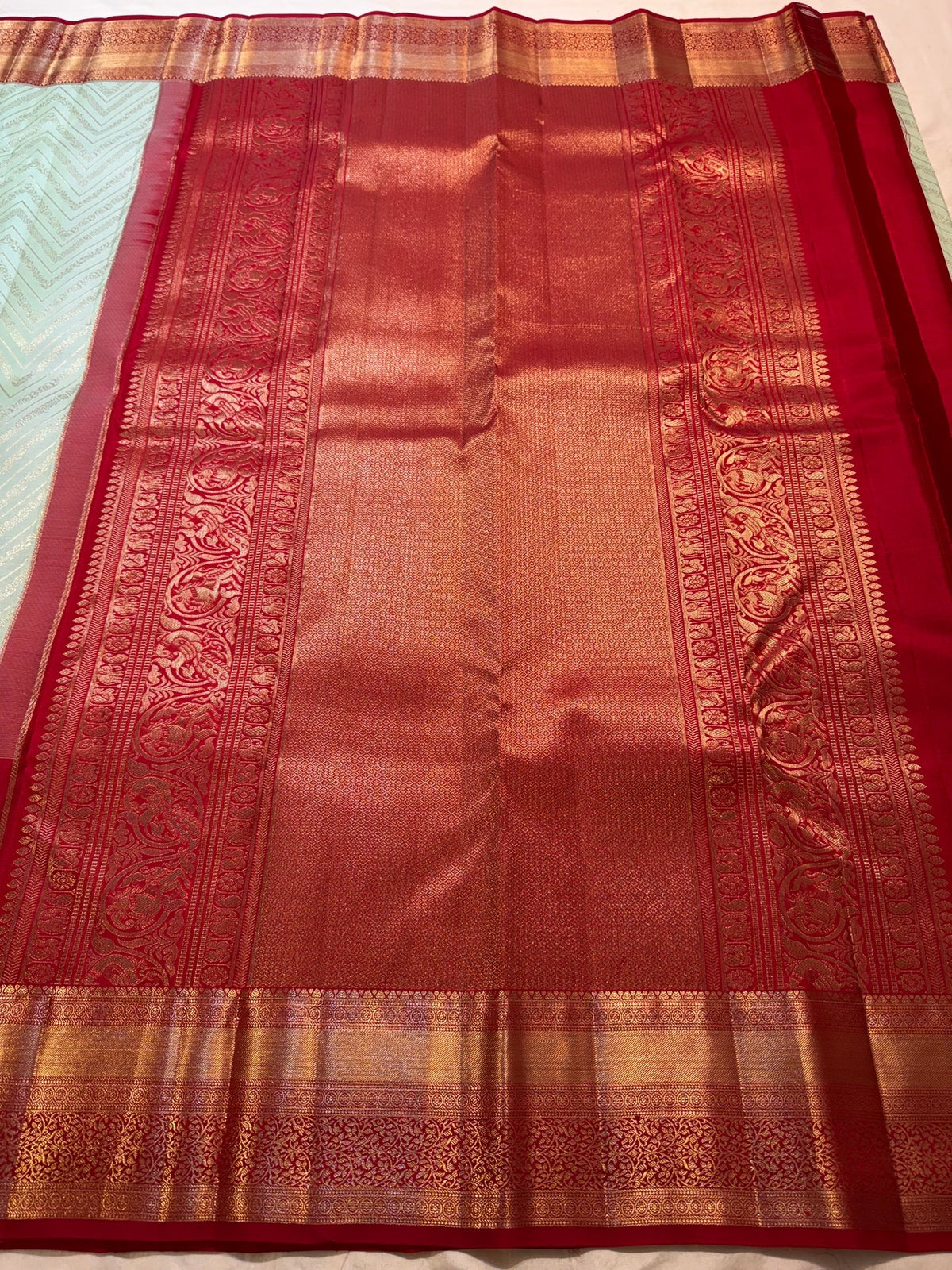 Pista green Kanjivaram silk saree with directional zari texture