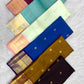Lotus-petal peach Kanchipuram pallu with long varisai zari bands and alternating ornamental woven panels.