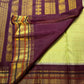 Close view of fine classic-gold zari lines across pistachio-green Kanchipuram silk.