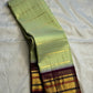Pistachio-green Pure Silk Kanjeevaram Korvai saree with a deep aubergine-purple gold-zari border.
