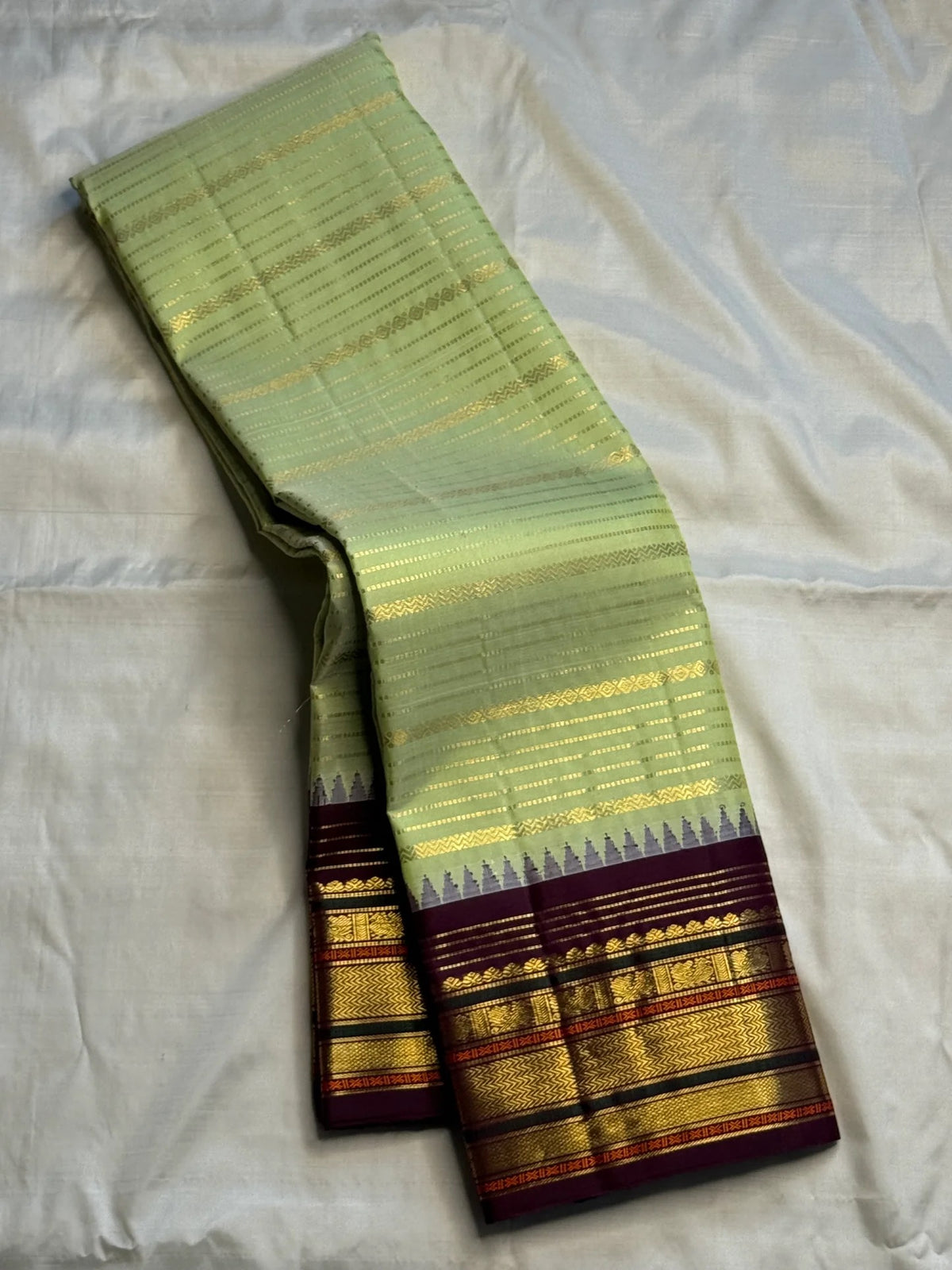Pistachio-green Pure Silk Kanjeevaram Korvai saree with a deep aubergine-purple gold-zari border.