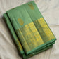 Fresh pistachio and lime-toned handwoven Kanchipuram silk with widely spaced traditional zari buttas.