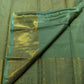 Pistachio-green silk saree with broad stacked gold-toned zari border and spaced body motifs.