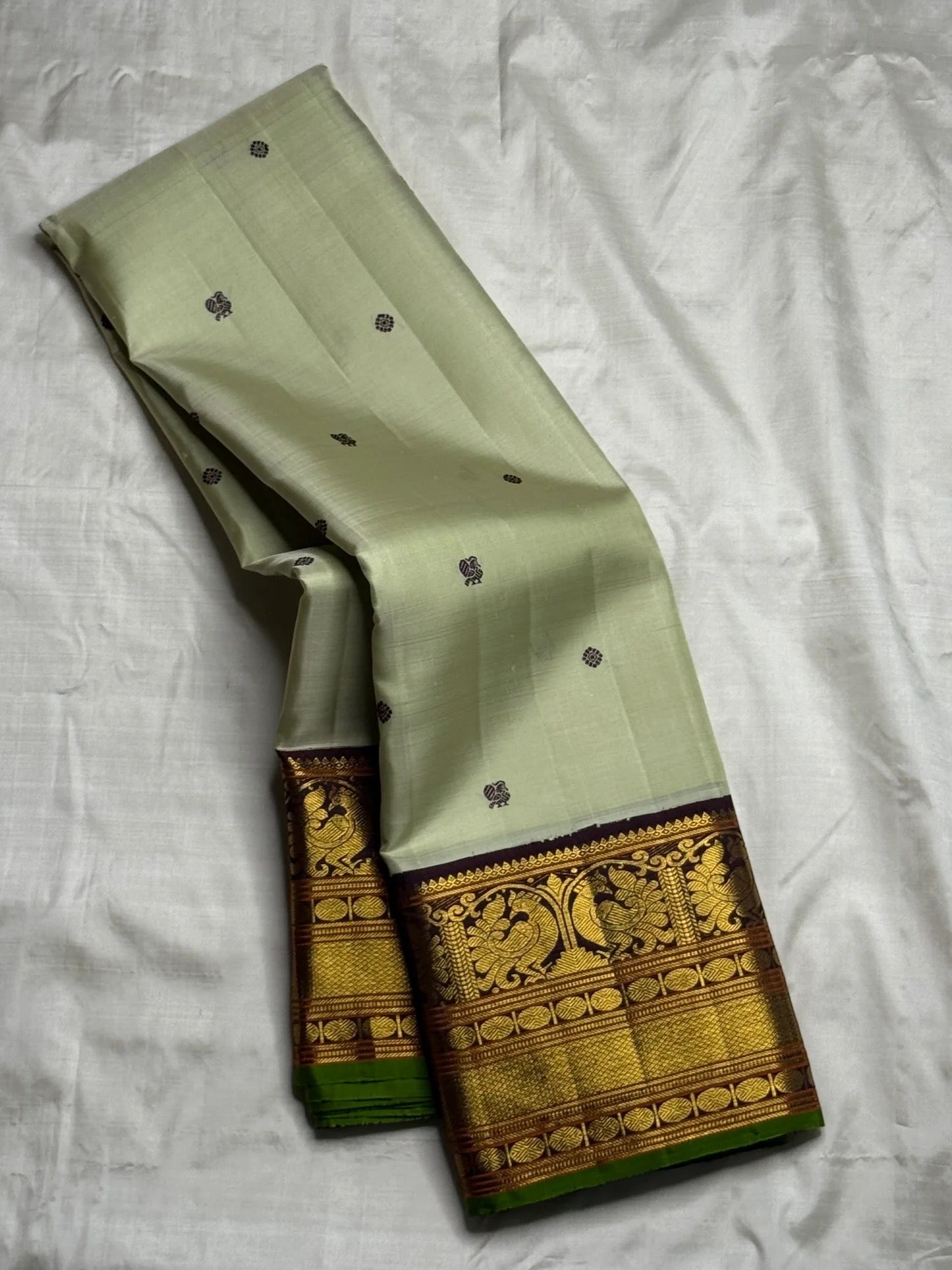 Handwoven pistachio green pure silk Kanchi Pattu saree with mayil chakram butta and deep purple border — Idam Living