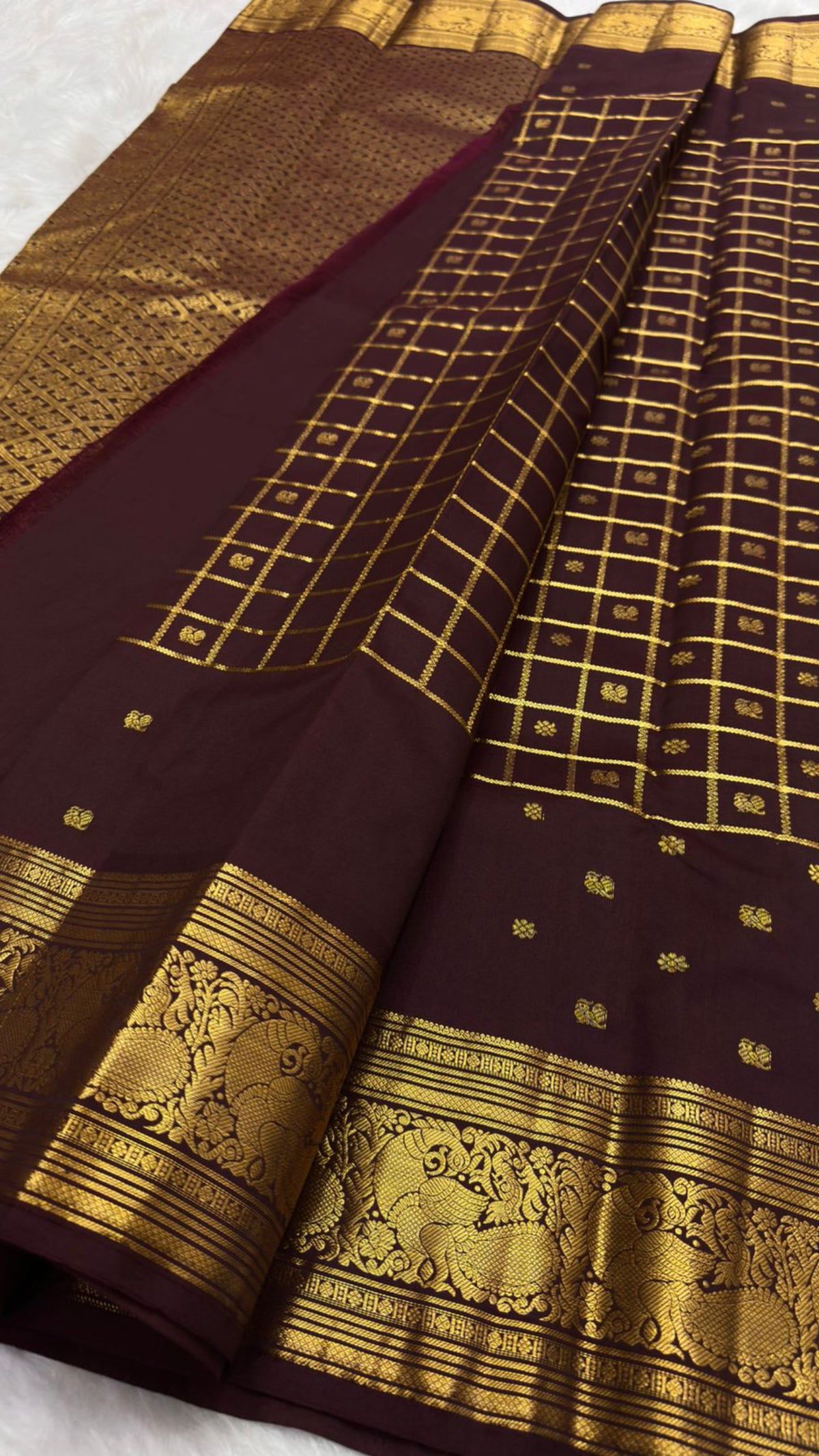 Handwoven plum-brown Kanjivaram silk with petite zari buttas and antique-gold Mayil Pettu border