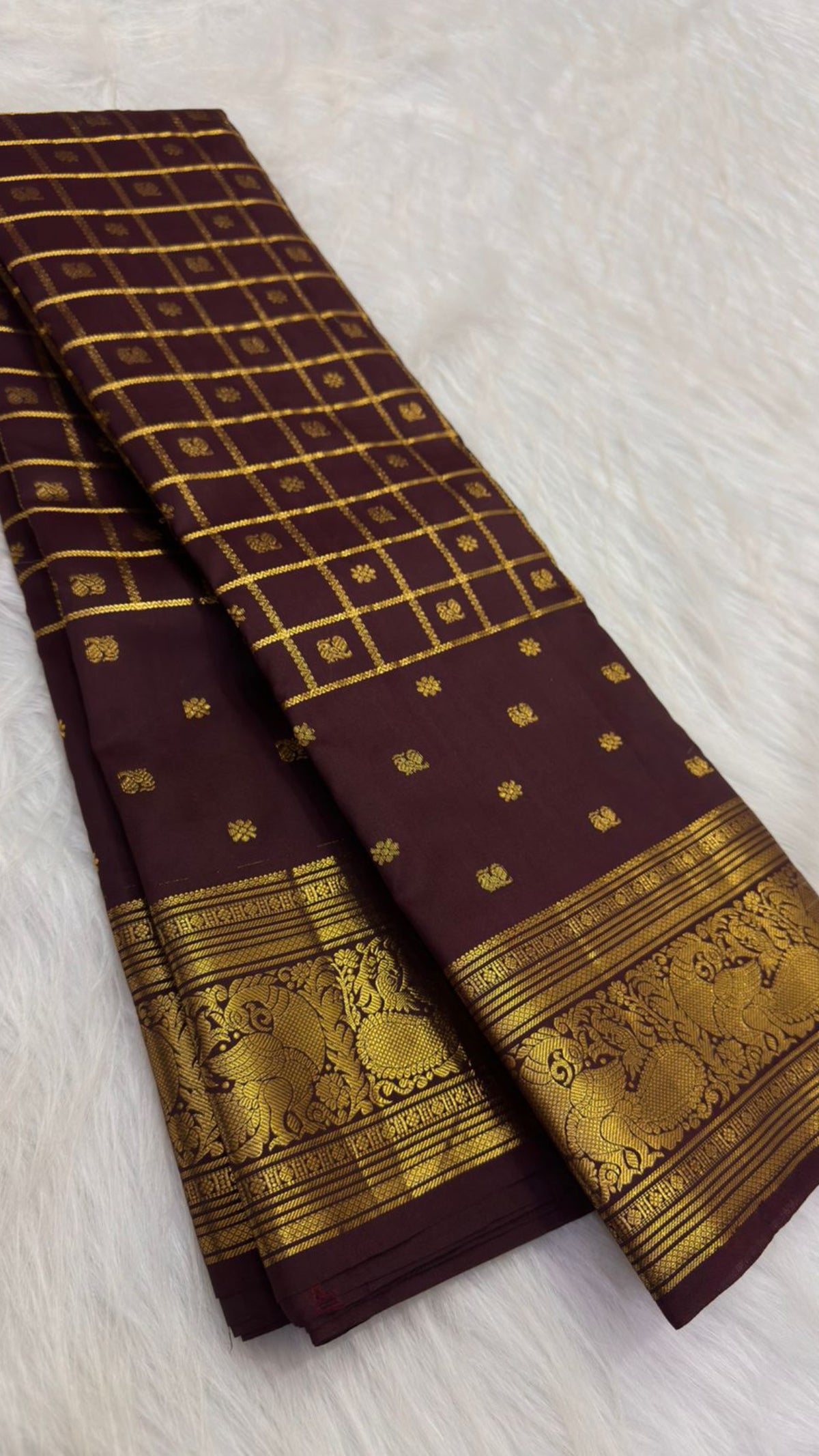 Deep plum-brown Lightweight Kanchipuram silk saree with gold zari kattam and ornate Mayil border