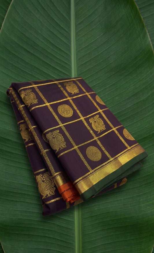 Plum deep brown Pure Kanchipuram silk saree with antique gold zari kattam and Ganga Jamuna petite border folded view