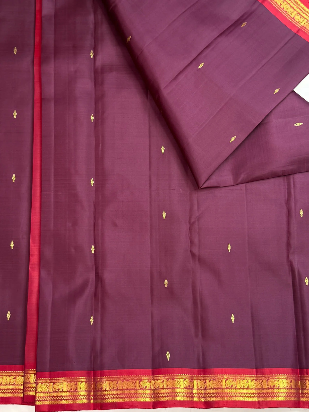 Kathiripoo Plum pure silk Kanchipuram butta saree with chedi floral kolam buttas, close view of the body