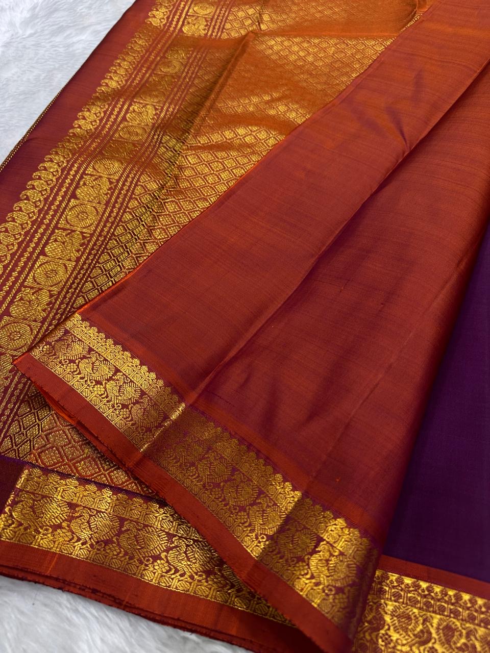 Burnt Rust contrast border on Muted Plum Purple Kanjivaram saree.