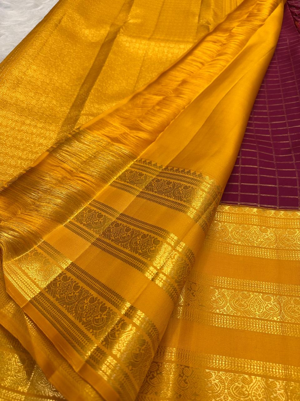 Plum purple body detail showing the zari kattam pattern and tiny gold buttas.