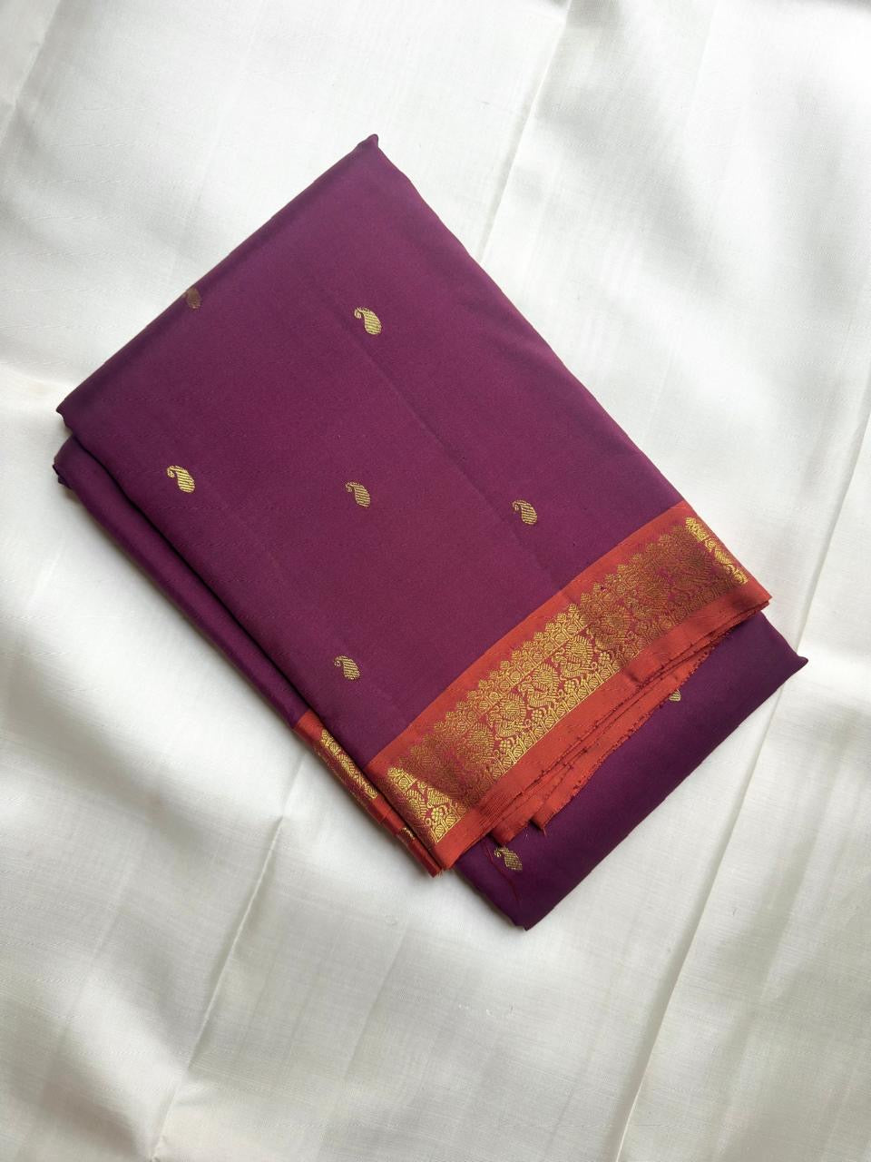 Muted Plum Purple pure silk Kanchipuram saree with antique-gold woven detailing.