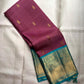 Plum Kanjivaram silk saree with petite Maanga gold buttas and Turquoise Pettu