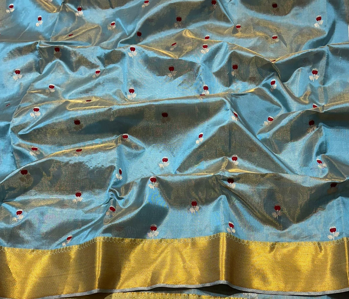 Powder blue Chanderi saree showing red floral butta detail