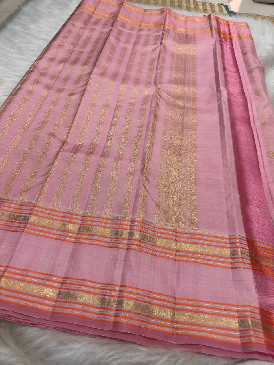 Powder pink Kanjivaram saree with orange gold border