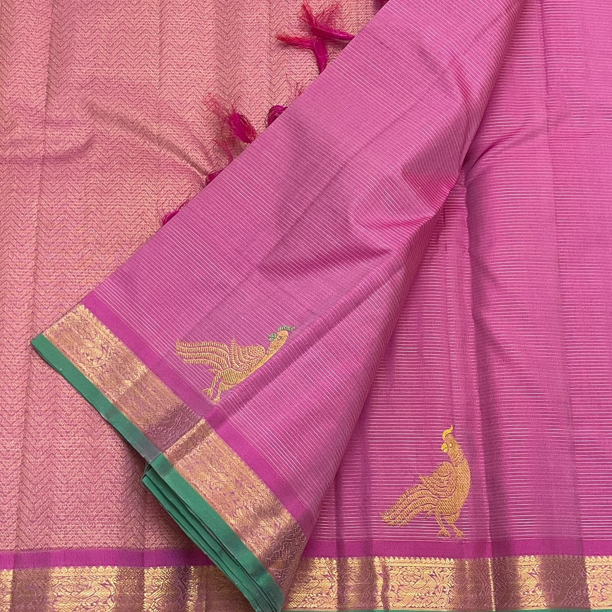 Close view of Kili parrot motif with contrast green meena on orchid pink silk