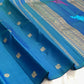 Handwoven peacock blue Kanjivaram silk saree with Kili parrot pallu, zari vine panels and deep green tassels