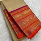 Close view of Mayil gold zari motifs woven into Rani Pink and orange Varisaipet border.