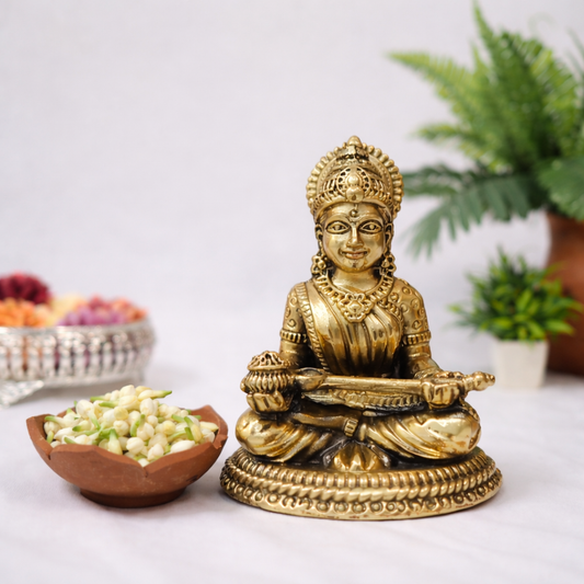 Pure solid brass Saraswati statue seated with veena, antique gold tone Hindu goddess idol for pooja room and sacred decor