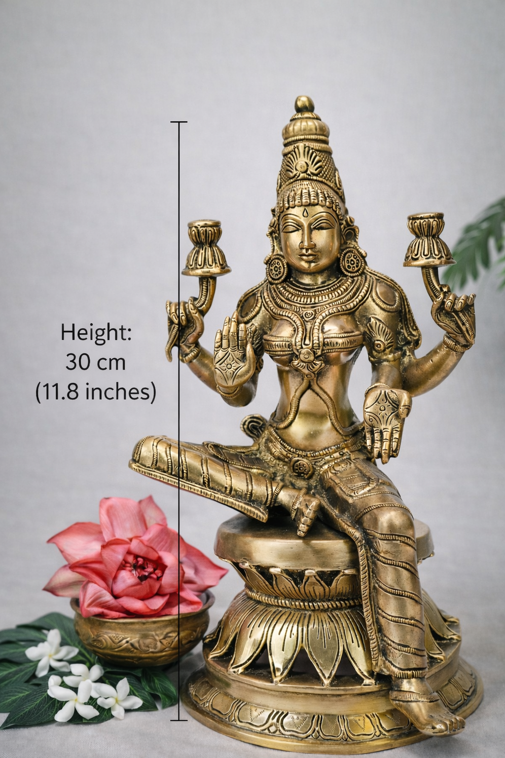 Pure brass seated Lakshmi statue with intricate carvings, front view with 30 cm (11.8 inches) height dimension marking, studio background.