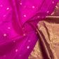 Detail of the purplish pink Chanderi silk body with small gold-toned buttas against the luminous gold-toned pallu