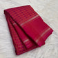 Handwoven raspberry pink KanchiPattu saree showcasing the all-over 1000 Butta design.